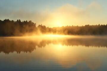 Fototapeta premium foggy lake at sunrise, where the reflection of golden mist hovers over the water