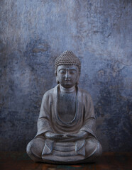 Meditating Buddha Statue on dark background. Soft focus. Close up. Copy space	