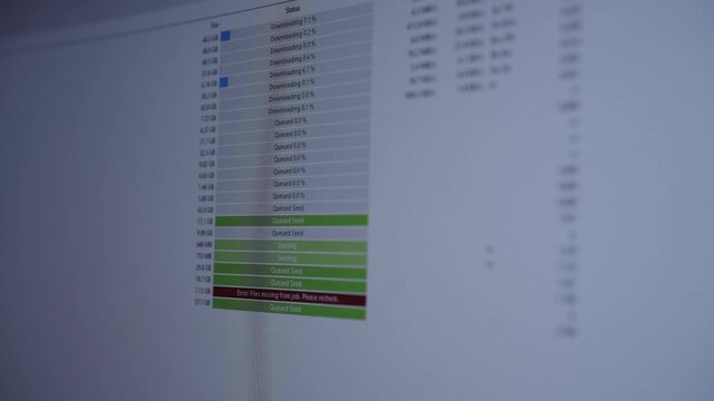 Computer screen showing torrent client application with file download and upload statuses, including progress bars and noticeable error message about missing files, close-up, no people, slow motion.
