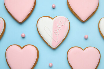 Fototapeta premium Sweet heart-shaped cookies and sprinkles on blue background. Valentine's Day celebration