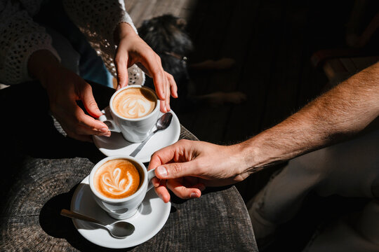 Couple enjoying coffee together with latte art in relaxing atmosphere