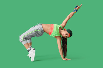 Female hip-hop dancer on green background