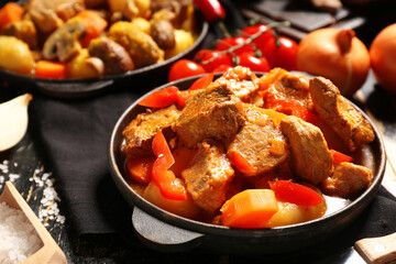 Baking dishes of tasty beef stew, closeup