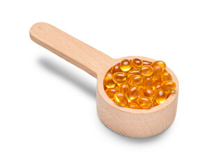Scoop with vitamin E capsules on white background