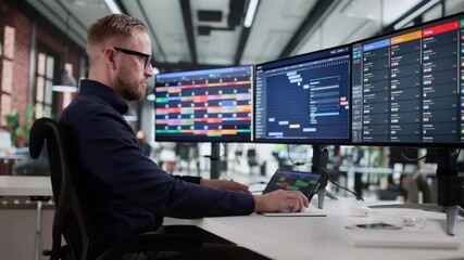 Office Man Using Multiple Screen PC