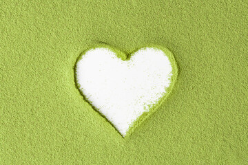 Creative mockup with heart-shaped cutout in vibrant green matcha powder on white background,...