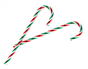 Sweet Christmas composition with striped candy canes in heart shape, symbol of love, joy, and festive holiday spirit. High quality photo