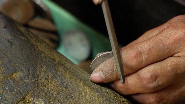 Silversmith crafts intricate silver in Celuk Village, Bali, with focus and care