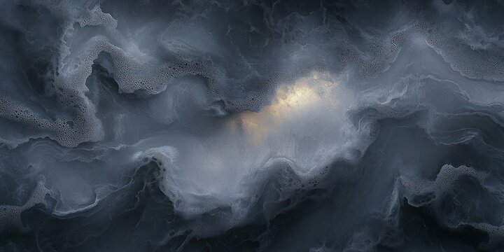 Close-up of dark swirling water with foam and bubbles creating abstract patterns with a subtle light reflection in the center
