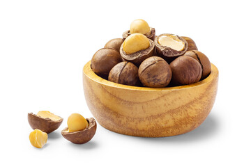 Macadamia nuts with nutshell in wood bowl isolated on white background