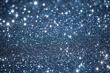 Close-up of sparkling silver glitter particles scattered with bright reflective light creating a festive and magical shimmering effect