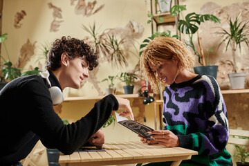 Stylish couple sharing ideas over coffee in a cozy cafe garden setting