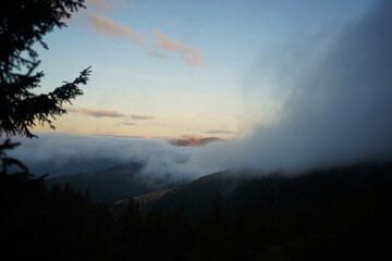 Mountain landscapes with mist, clouds and morning light in the Carpathians