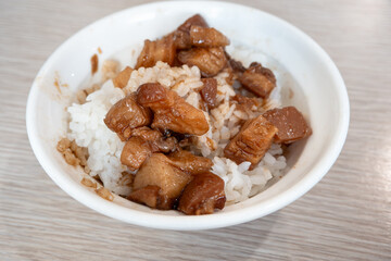 Braised pork belly meat over cooked rice.