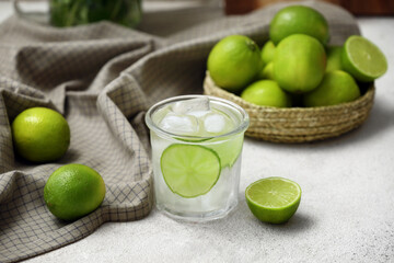 Glass of lime infused water on white background, closeup