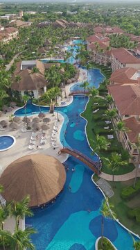 Vertical aerial drone view of luxury resort with large, winding swimming pool, Bavaro, Dominican Republic