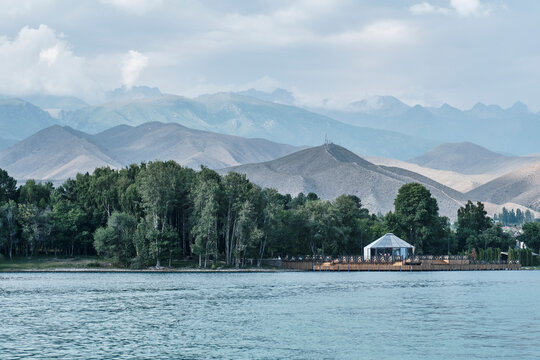 Rukh Ordo cultural center on Issyk-Kul shore with Tian Shan mountains backdrop