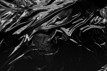 Transparent plastic wrap on a black background