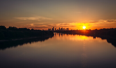 Obraz premium Vistula River and city downtown in Warsaw, capital of Poland - evening view from Siekierkowski Bridge