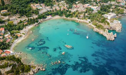 Alypa beach and marina in heart shaped beach in Palaiokastritsa, Corfu Island, Greece