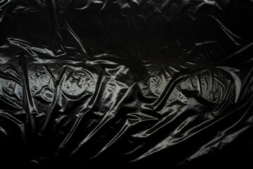 Transparent plastic wrap on a black background