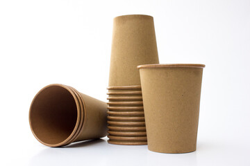 Several stacks of brown paper coffee cups isolated on white background. These cups are eco- friendly, suitable for coffee businesses in cafes.