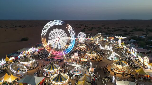 Vibrant Aerial View of Pushkar Camel Fair at Dusk Ferris Wheel and Festive Atmosphere