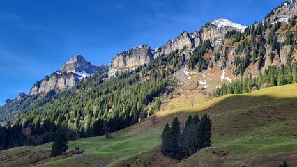 A beautiful mountain scene in the Bernese Oberland, Switzerland, showing a clear view of an impressive mountain range illuminated by warm autumn light