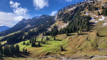 A beautiful mountain scene in the Bernese Oberland, Switzerland, showing a clear view of an impressive mountain range illuminated by warm autumn light