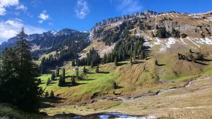 A beautiful mountain scene in the Bernese Oberland, Switzerland, showing a clear view of an impressive mountain range illuminated by warm autumn light