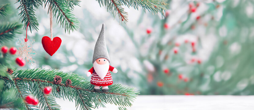 Banner of Christmas gnome Nisse with gray hat and red outfit, perched on a pine branch adorned with festive decorations, creating a joyful holiday atmosphere with soft bokeh background