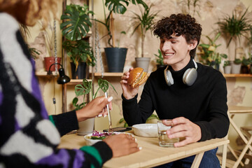 Stylish couple enjoying delicious food and drinks in a cozy cafe setting