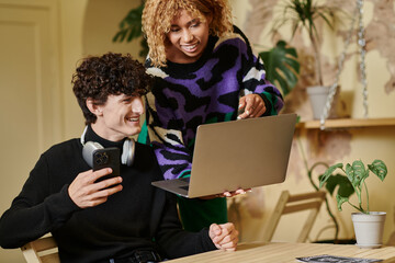 Couple sharing joy and ideas while working together in a cozy cafe setting