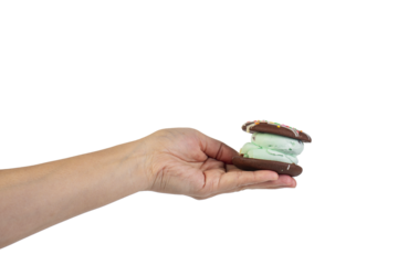 Mint filled chocolate chip cookies in hand on transparent background