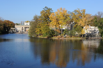 Trees with colorful leaves during foliage in autumn in an old park Lazienki in Warsaw, Poland