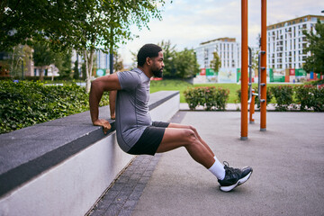 African American Man Outdoors Doing Dips To Lose Weight And Get Fit