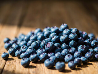 Pile of fresh blueberries on a rustic wooden surface