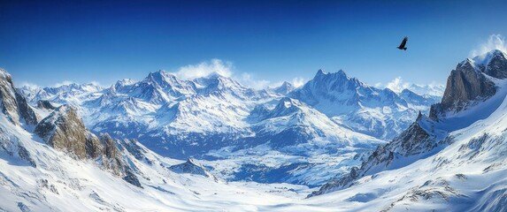 Vast snowy mountain range under clear blue sky with a large bird soaring above rugged peaks