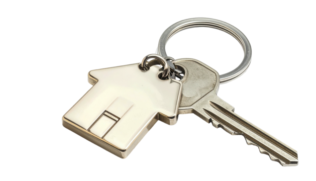Shiny key and house keychain lie on black, silver and white, symbolising home, security, and property ownership