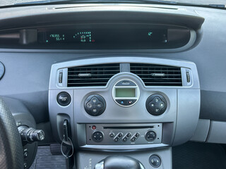 Fototapeta premium Dashboard display of a car showing the odometer reading and temperature during a sunny day drive