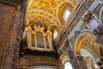 Pipe organ in the Church of St. Louis of the French (San Luigi dei Francesi), Rome. Gilded baroque architecture and marble details.