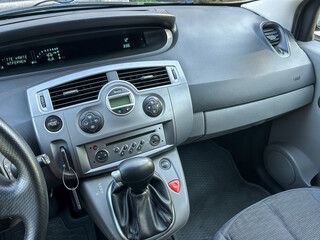 Naklejka premium Dashboard view of a compact car showcasing modern controls and sleek design during a sunny afternoon drive
