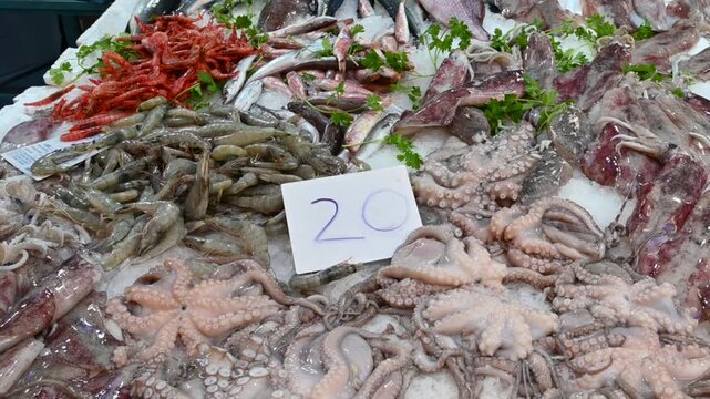 Naples, Italy, December 30, 2024. Panning footage of a large fresh fish stall at a local market. Lifestyle with local and healthy food, the Mediterranean diet.