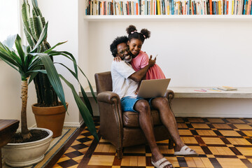 Father and daughter hugging and sharing a happy moment at home