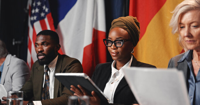Fototapeta Press conference, tablet and woman with team for delegation, international government and panel. Summit, people and politician at speech for diplomacy discussion, global forum or policy update