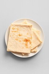 Plate with fresh thin lavash on grey background