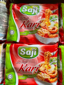 Paka, Malaysia - 23.10.2025 : Stack of Saji Kari instant noodle soup packages