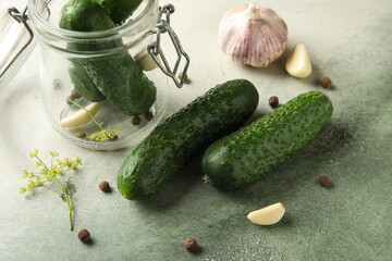 Fresh cucumbers for preservation on grunge background