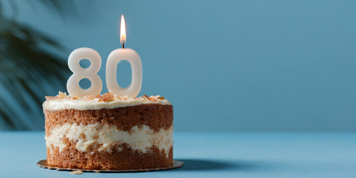 A delightful cake with a lit candle, celebrating the number eighty. This festive image symbolizes a milestone age, evoking feelings of celebration and remembrance.