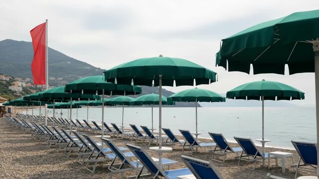 Beach scene with rows of umbrellas and lounge chairs